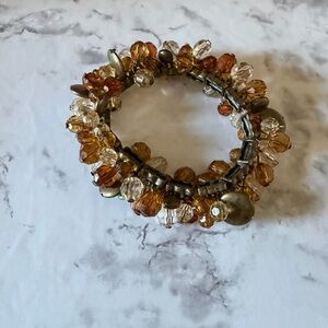 Elegant Acrylic Beaded Bracelet with Gold and Brown Accents.